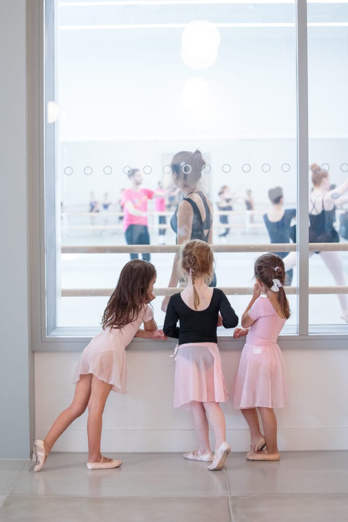 3 young dancers looking into an RAD studio