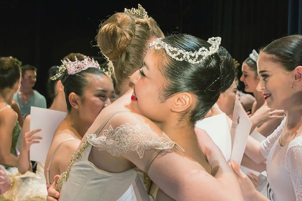 dancers hugging after a competition